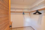 A large walk-in closets offers lots of space for storage